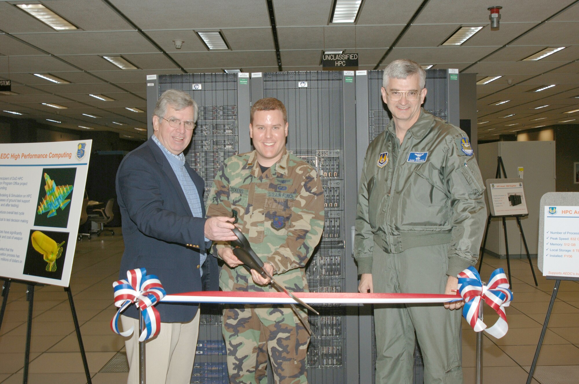 From left to right Dr. Edward Kraft, center technical advisor, 2nd Lt. Rickey Dickens, project manager for the high performance computing maintenance project and Center Commander Brig. Gen. David L. Stringer cut the ribbon for the new high performance system.