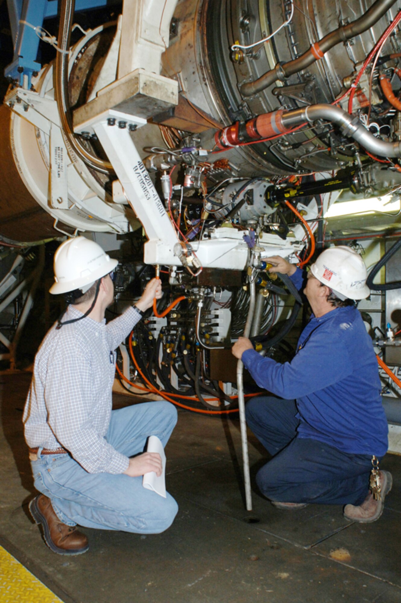 AEDC Test Operations personnel make final inspections of an F118-GE-100 engine prior to altitude testing.  The engine, which powers the B-2 bomber, is part of the F118 Service Life Extension Program (SLEP), which supports the Air Force’s Component Improvement Program.