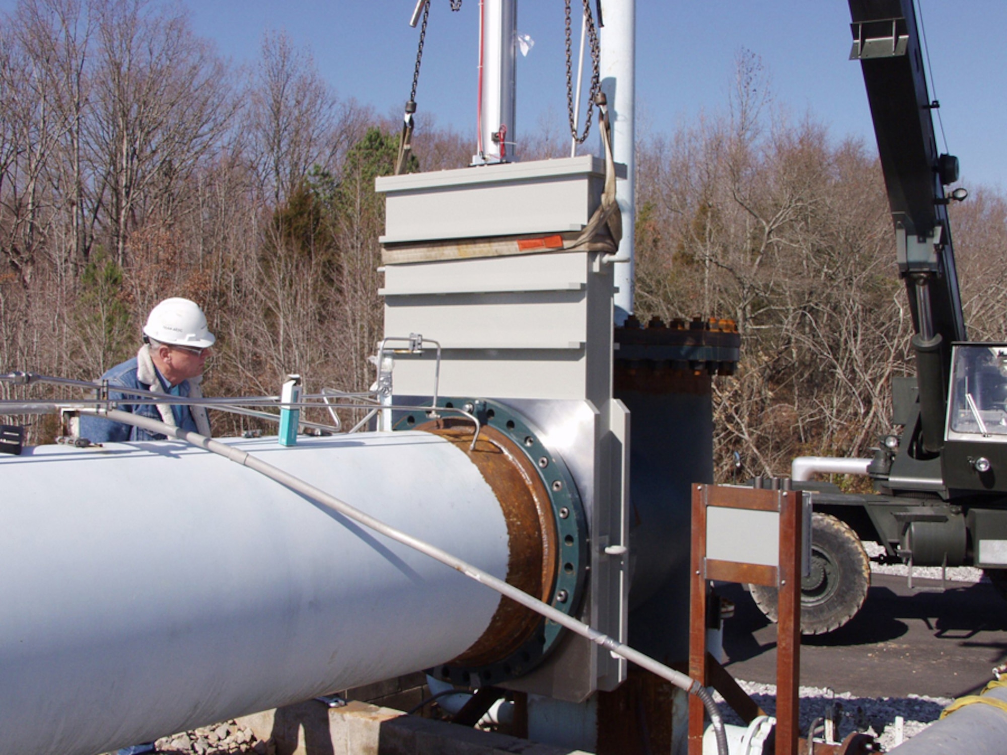 Milton Boyer, an ATA operating engineer, works with an installation crew to put a large valve into place above the repaired upper ducting for G-Range. He was on hand to inspect the alignment of the valve to ensure the crane operator had it correctly positioned. A mishap in November 2004 severely damaged the original valve. 