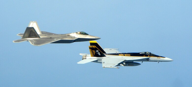 F-22 Raptors deployed to Kadena Air Base, Japan, trained with U.S. Navy F/A-18 Super Hornets April 26, 2007, near the waters of Okinawa.  The Super Hornets, from VFA-27 "The Royal Maces," are stationed at Naval Air Facility Atsugi, Japan, and are the U.S. Navy's newest frontline carrier-based fighter.  The Raptors are from the 27th Fighter Squadron, Langley Air Force Base, Va., and have been deployed to Kadena since February.  The training exercises focused on the next generation fighter capabilities between the two aircraft.  (U.S. Navy courtesy photo)