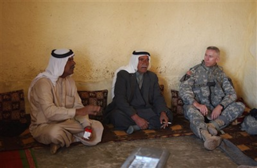 U.S. Army Maj. Mark Reeves sits and talks with village leaders from the village of Musayd, west of Mosul, Iraq, on April 25, 2007.  Reeves is attached to the 2nd Battalion, 7th Cavalry Regiment, 4th Brigade Combat Team, 1st Cavalry Division.  