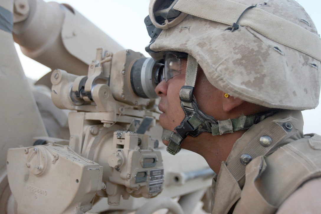 COMBAT OUTPOST RAWAH, IRAQ – Cpl. Fernando Macias, a cannon-crewman with Battery R, 5th Battalion, 11th Marine Regiment, attached to Task Force Highlander, Regimental Combat Team 2, looks through the sights to ensure Phyxius, an M198 Howitzer artillery cannon, will hit its target. The battery conducted a direct-fire training mission followed by an illumination mission in support of 1st Light Armored Reconnaissance Battalion. Official Marine Corps Photo By Cpl. Ryan C. Heiser.