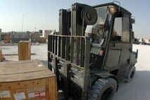 SOUTHWEST ASIA -- Tech. Sgt. Lesha Stanley, 379th Expeditionary Logistics Readiness Squadron, uses a forklift to reposition a pallet of goods to be processed. Sergeant Stanley is deployed here from Misawa Air Base, Japan. (U.S. Air Force photo)
