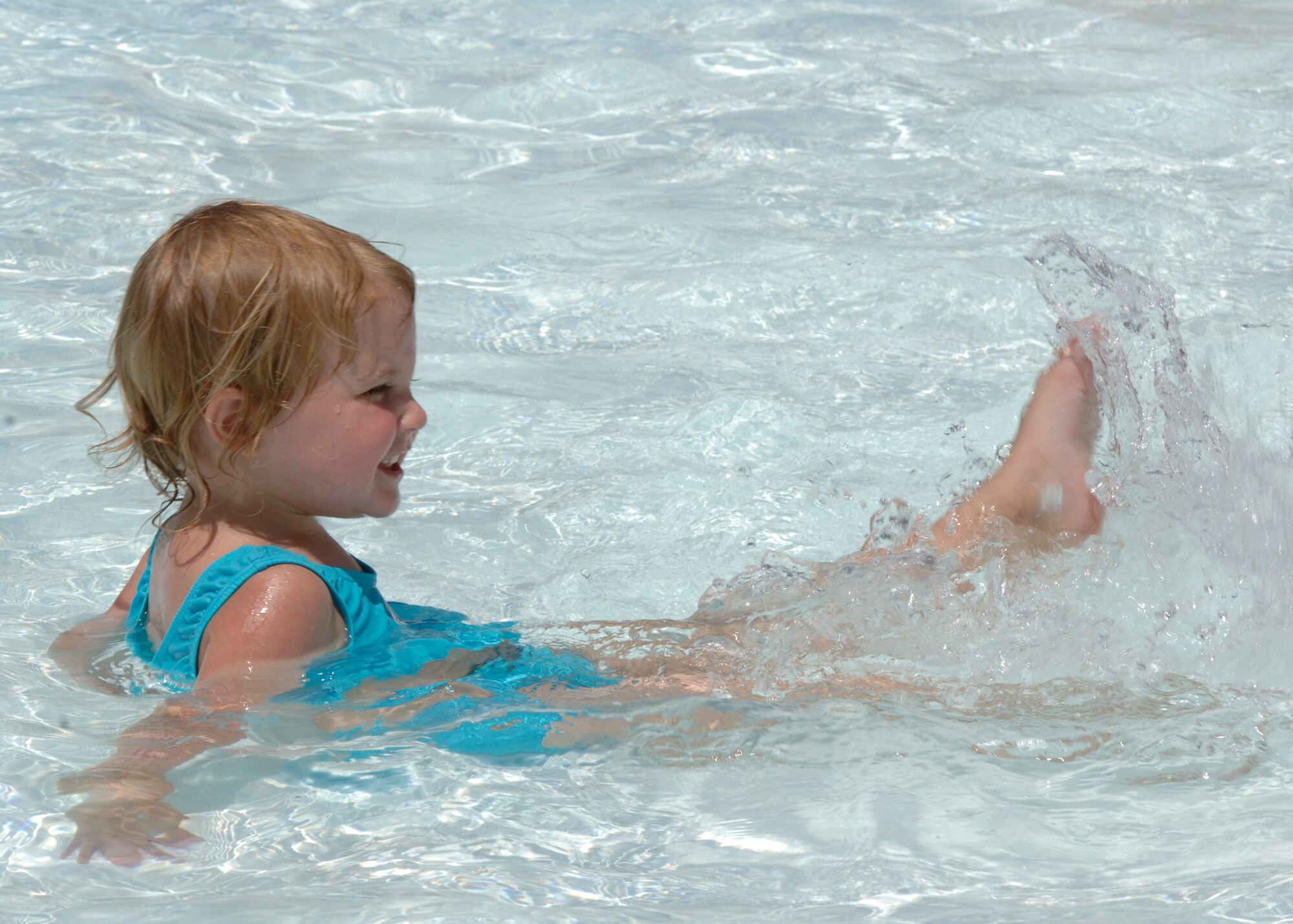 MCCONNELL AIR FORCE BASE, Kan. -- Kamryn Richardson, 2, a Team McConnell family member youth, splashes her feet in the pool at Rock River Rapid’s annual military appreciation day in Derby, July 26. (Photo by Airman First Class Jessica Corob)