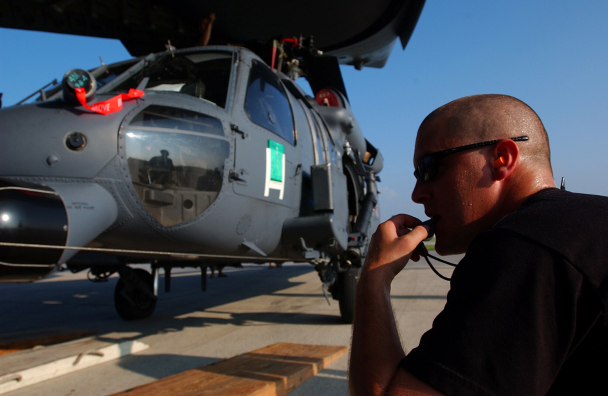 Senior Airman James P. Morin from the 33rd Rescue Squadron, Kadena Air Base, Japan, supervises the loading of an HH-60 Pave Hawk helicopter onto a C-17 GlobeMaster July 30 in preparation for deployment to Kandahar, Afghanistan. This is the second time since January the squadron has deployed to Afghanistan. A group of squadron Airmen returned in May from a 4-month deployment to Kandahar, where this second group will conduct combat search and rescue and medical rescue missions in support of Operation Enduring Freedom. (U.S. Air Force photo/Staff Sgt. Reynaldo Ramon)