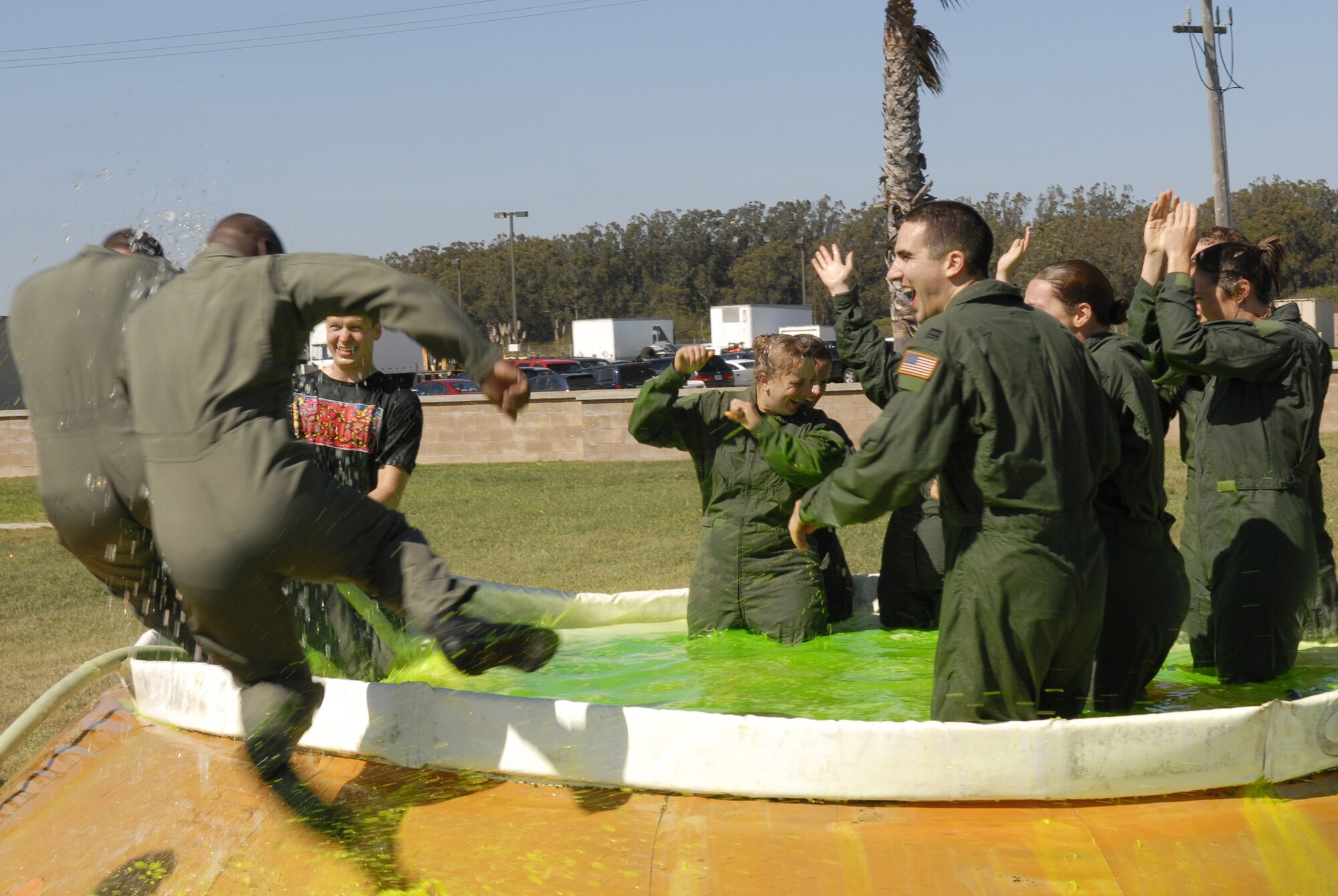 VANDENBERG AIR FORCE BASE, Calif. -- Celebrating the final flight of the 76th Helicopter Squadron, Airmen jump into a pool of bubble bath and green sea dye on July 31. The 76th HS is set to inactivate during a ceremony at the hangar Aug. 2, bringing a 49-year era of helicopters at Vandenberg to a close. The 76th came into existence at Vandenberg in May 1993 as a Rescue Flight and changed to a Helicopter Squadron in October 2005.   (U.S. Air Force photo/Airman 1st Class Adam Guy)