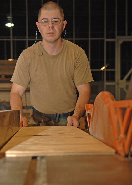 SEYMOUR JOHNSON AIR FORCE BASE, N.C. - Staff Sgt Roy Goldstein, 4th Logistics Readiness Squadron, prepares to use a radial arm saw to cut wood used to make pallets on August 1. (U.S. Air Force photo by Senior Airman Jessica Klingler) 