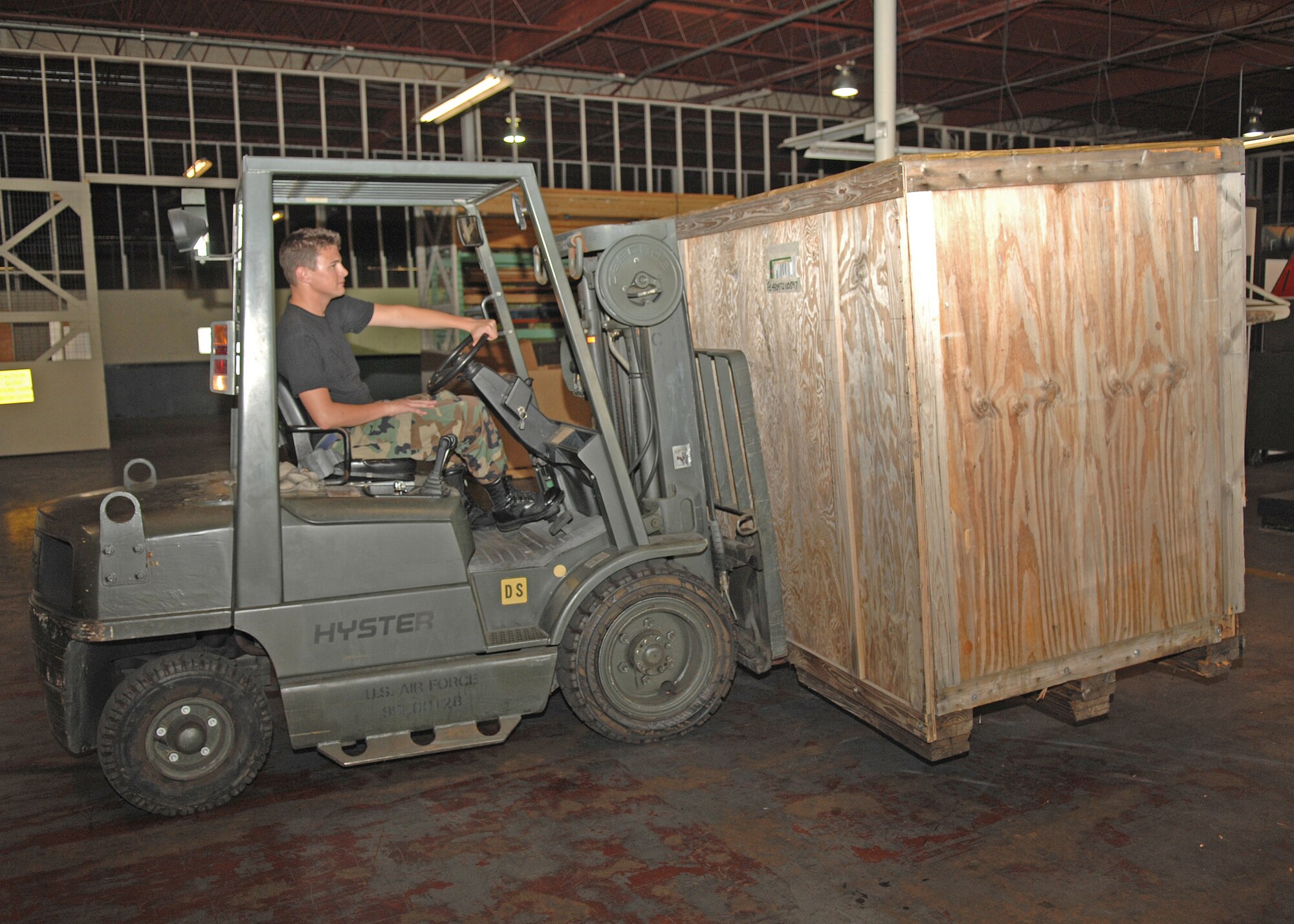 Airman 1st Class Brett Moeller, 4th Logistics Readiness Squadron, Seymour Johnson AFB, Goldsboro, North Carolina drives a forklift with a crate of aircraft parts in it to be stored in the LRS warehouse on 1 August 2007.
(U.S. Air Force photo by Senior Airman Jessica Klingler)