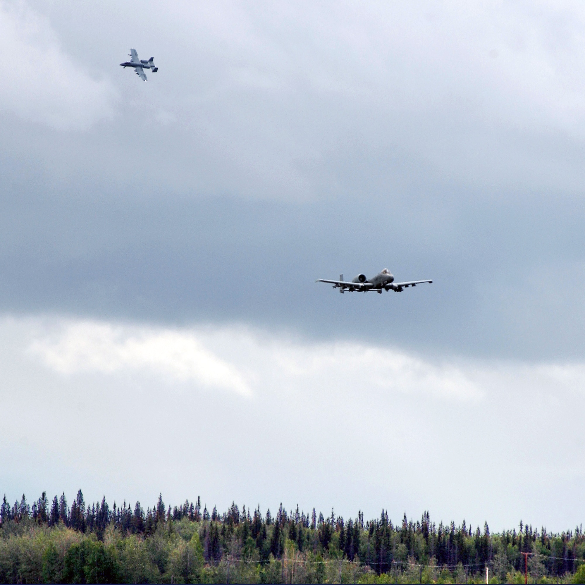 Two A-10 Thunderbolt IIs from the 355th Fighter Squadron conduct their last flight over Eielson Air Force Base, Alaska, July 31. The first two A-10s arrived at Eielson Dec. 18, 1981; the last two A-10s are set to leave Aug. 15 for Moody AFB, Ga., and Gowen Field, Idaho. (U.S. Air Force photo/Airman 1st Class Jonathan Snyder) 
