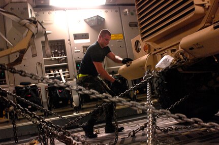 Airman 1st Class Michael Purcell chains down a Mine Resistant Ambush Protected armored vehicle on a C-17 Globemaster III at Charleston Air Force Base, S.C., for shipment to Iraq July 28. An estimated 3,500 MRAP vehicles are expected to be in Iraq by Dec. 31. Airman Purcell is assigned to the 437th Aerial Port Squadron. (U.S. Air Force photo/Tech. Sgt. Jeromy K. Cross) 

