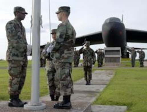 ANDERSEN AIR FORCE BASE, Guam - Members of the Andersen Honor Guard and Air Force Office of Special Investigation, Detachment 602, conduct reveille in front of Arc Light Memorial park on Andersen Air Force Base commemorating the 60th Anniversary of AFOSI.  Situated across the Pacific dateline, Det 602 is the first AFOSI detachment to raise the flag during the year-long celebration.  (Graphic by Maj R.A. Dowdell)