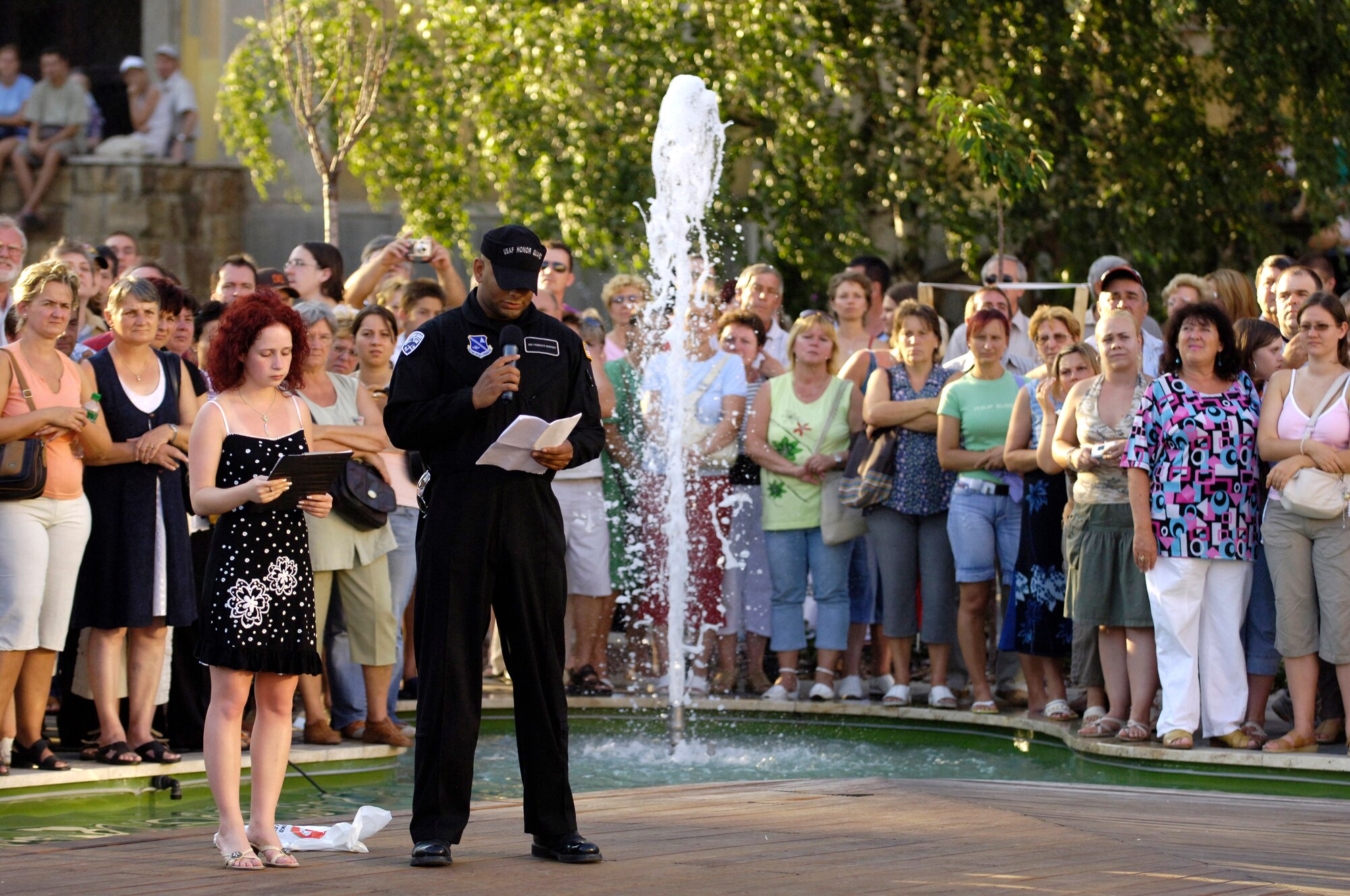 The U.S. Air Force Honor Guard Drill Team performance is narrated in Hungarian and English by Agatha Rostonics, the Hungarian translator to the U.S. Air Force, and Senior Airman Francisco Garrigas, a drill team trainer. The team represented the U.S. armed forces during Regimentfest in Miskolc City, Hungary, July 28. (U.S. Air Force Photo/Senior Airman Daniel R. DeCook)