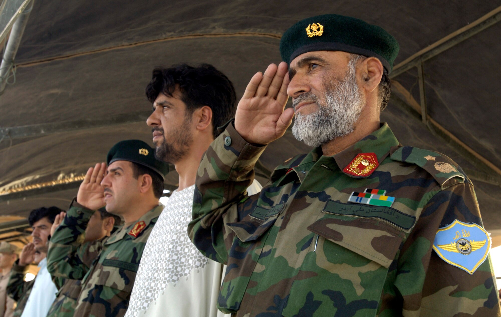 Afghan National Army Air Corps Brig. Gen. Mohammad Yousaf renders honors July 31 during a historic change-of-command ceremony at Kandahar Air Field, Afghanistan, that culminated a year-long effort to bring Kandahar under NATO control.  The ceremony marked the first time NATO has taken full control of a large airfield and operational staging base in an active operational theater using a multi-national team.  General Yousaf is the assistant commander of the ANA aviation garrison at Kandahar.  (U.S. Air Force photo/Master Sgt. Jim Varhegyi)