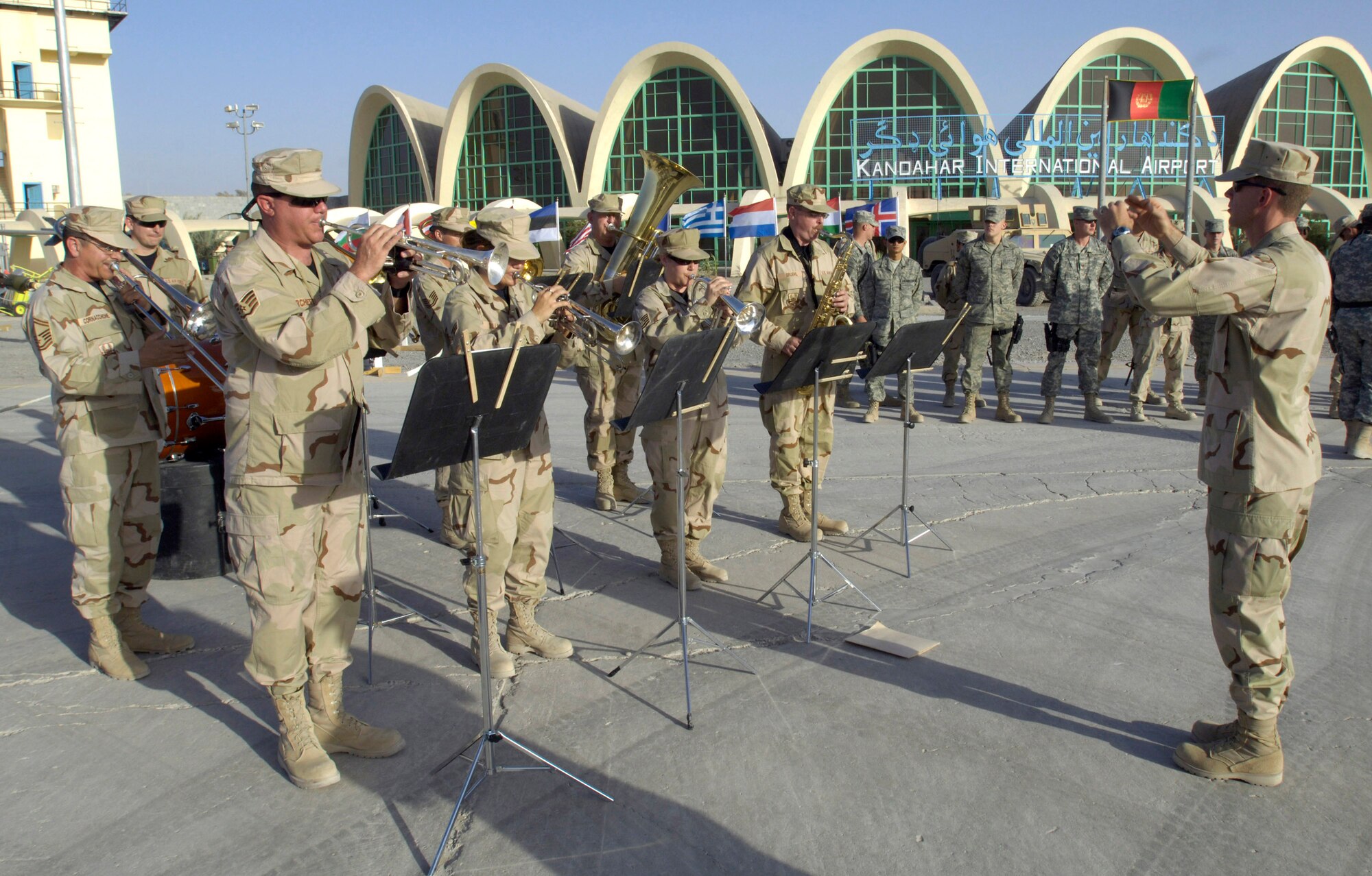 Maj. Chad Steffey directs the U.S. Central Air Forces band at Kandahar Air Field, Afghanistan, July 31 during a historic change-of-command ceremony that culminated a year-long effort to bring Kandahar under NATO control.  The ceremony marked the first time NATO has taken full control of a large airfield and operational staging base in an active operational theater using a multi-national team. (U.S. Air Force photo/Master Sgt. Jim Varhegyi)