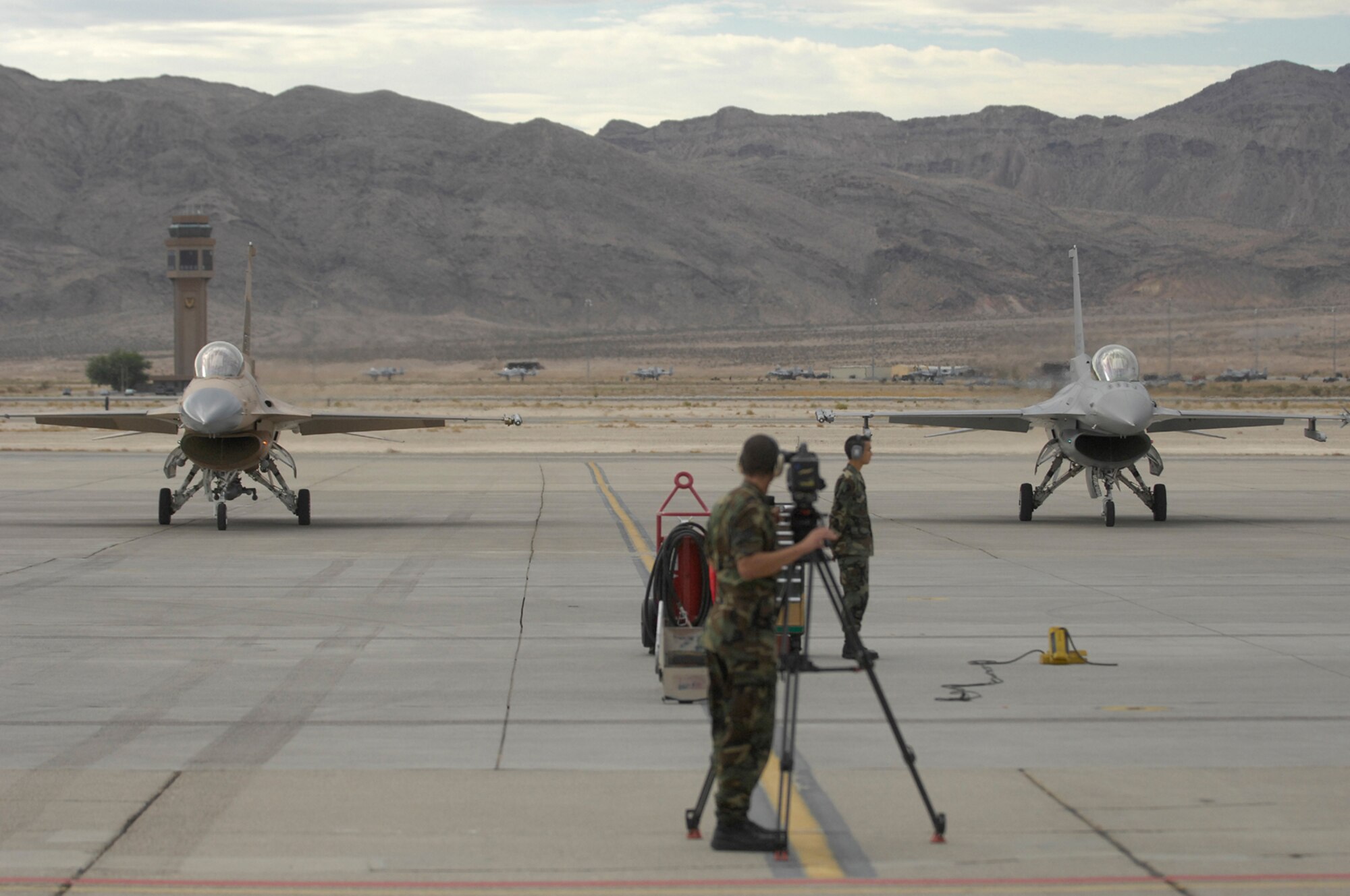 Brig. Gen. Steven Hoog (left) incoming commander 57th Wing, and Brig. Gen. William Rew (right), outgoing commander 57th Wing, taxi their F-16 Fighting Falcons onto the Nellis Air Force Base ramp.  The Generals took a ceremonial fly-by demonstrating an in-flight lead change just prior to landing and the official change of command ceremony July 31, 2007, at 8:57 a.m. (U.S. Air Force photo by Staff Sgt. Kenny Kennemer)