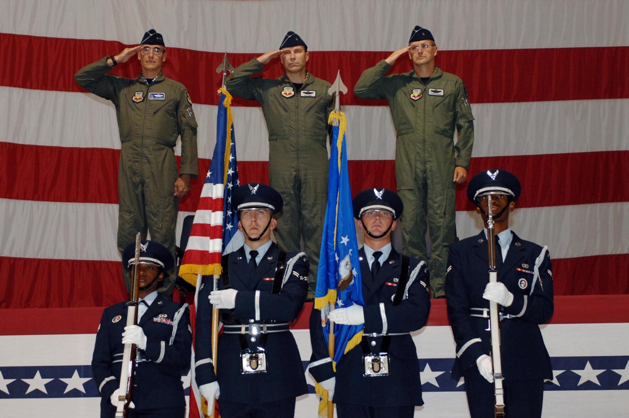 Maj Gen Mike Worden (left) commander U.S. Air Force Warfare Center, Brig Gen William Rew (center) outgoing commander 57 Wing, and Brig Gen Stephen Hoog, (right) incoming 57 Wing commander present arms during the Posting of the Colors for the  57 Wing Change of Command in the Thunderbird hangar here Monday, July 31 at 8:57 a.m.
 (Photo by Senior Airman Jason Huddleston)