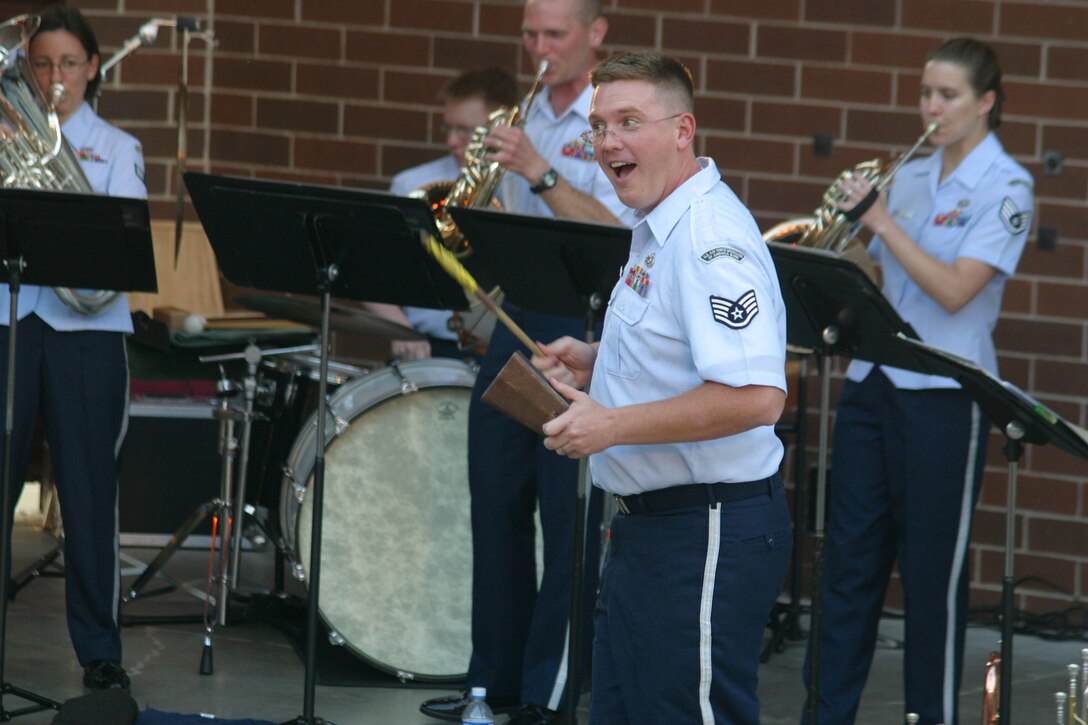 SSgt Jeff Reich of the USAF Heartland of America Band presents his skills as a cowbell soloist at Glenwood, Iowa's Davies Amphitheater during a Brass in Blue performance in June of 2007.