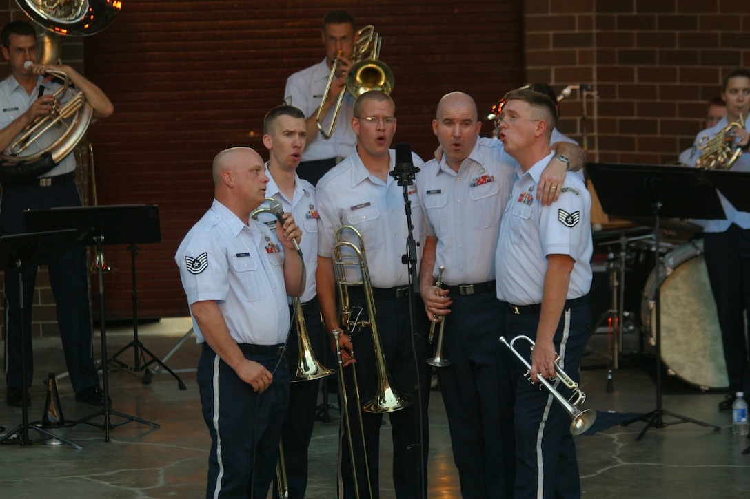 Members of the USAF Heartland of America Band's Brass in Blue play the part of rock star back-up vocalists during a performance of "Bohemian Rhapsody" in Glenwood, Iowa in June of 2007.