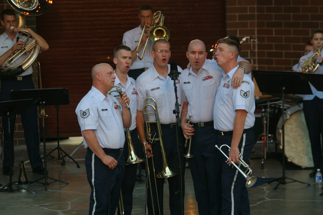 Members of the USAF Heartland of America Band's Brass in Blue play the part of rock star back-up vocalists during a performance of "Bohemian Rhapsody" in Glenwood, Iowa in June of 2007.
