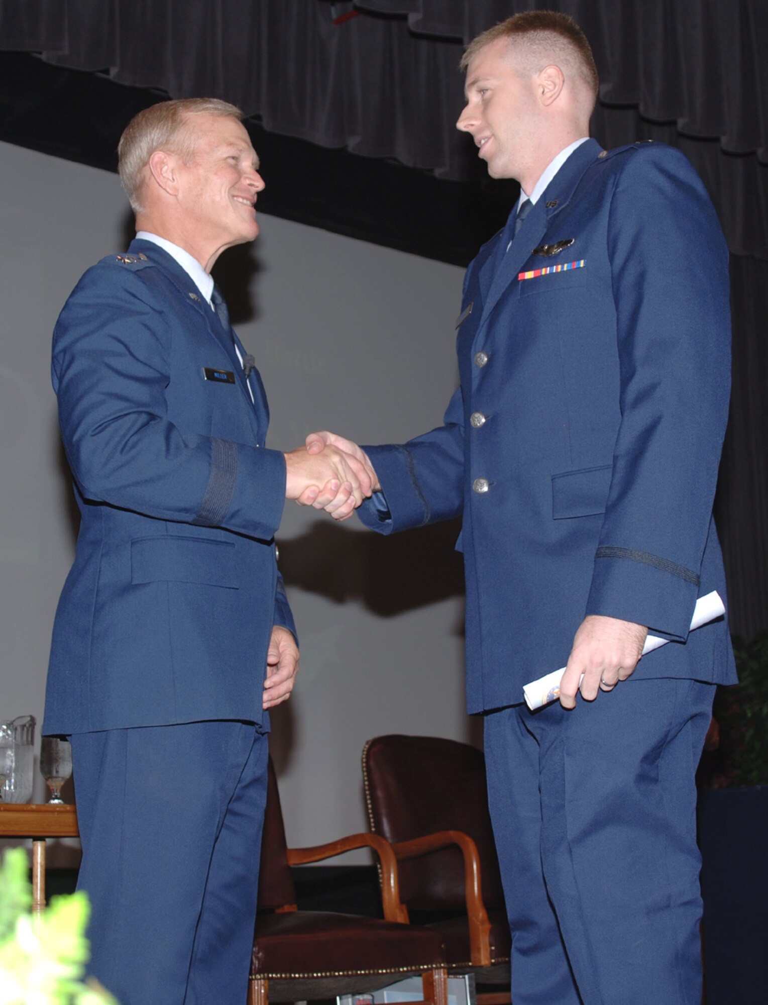 Major Gen. Steve Miller, Commandant of the Air War College, Maxwell AFB, Ala., congratulates a graduate of Specialized Undergraduate Pilot Training Class 07-12 during his visit to Columbus AFB July 27. (U.S. Air Force Photo by Airman 1st Class Danielle Powell)