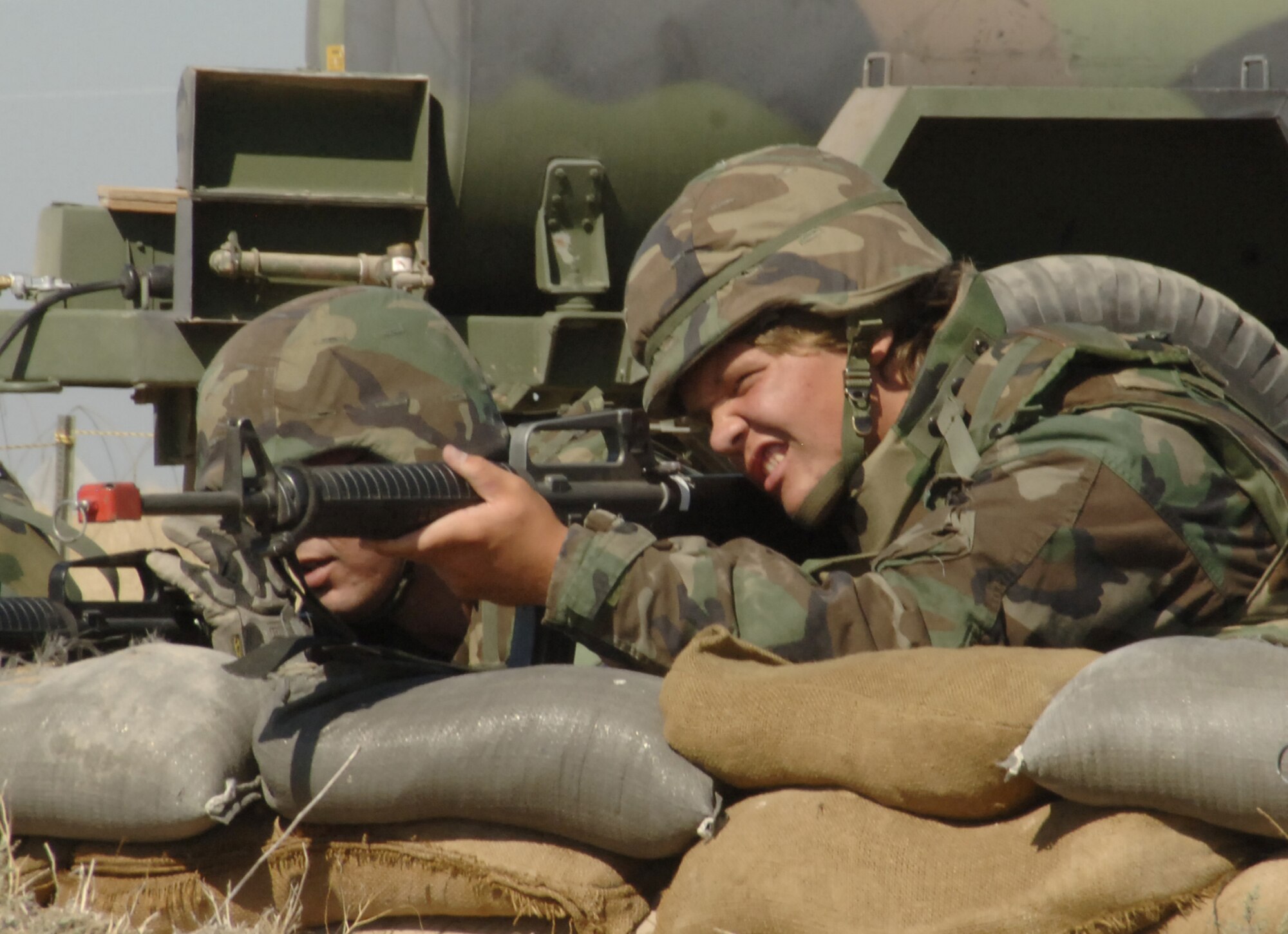 MOUNTAIN HOME AIR FORCE BASE, Idaho -- Mrs. Linda Ketterling, Mission Support Group Honorary commander, takes aim with an M-16 as Capt. Justin W. Monday, 726th Air Control Squadron Chief of Maintenance, offers pointers Friday during the Honorary Commanders Air Expeditionary Day.  During the half-day tour 20 Honorary Commanders learned what Gunfighters go through during a deployment, including firing M-16 rifles, eating Unit Ground Rations and experiencing a ground assault against the deployed base. (U.S. Air Force Photo/ by Senior Airman Megan P. Lyon)

