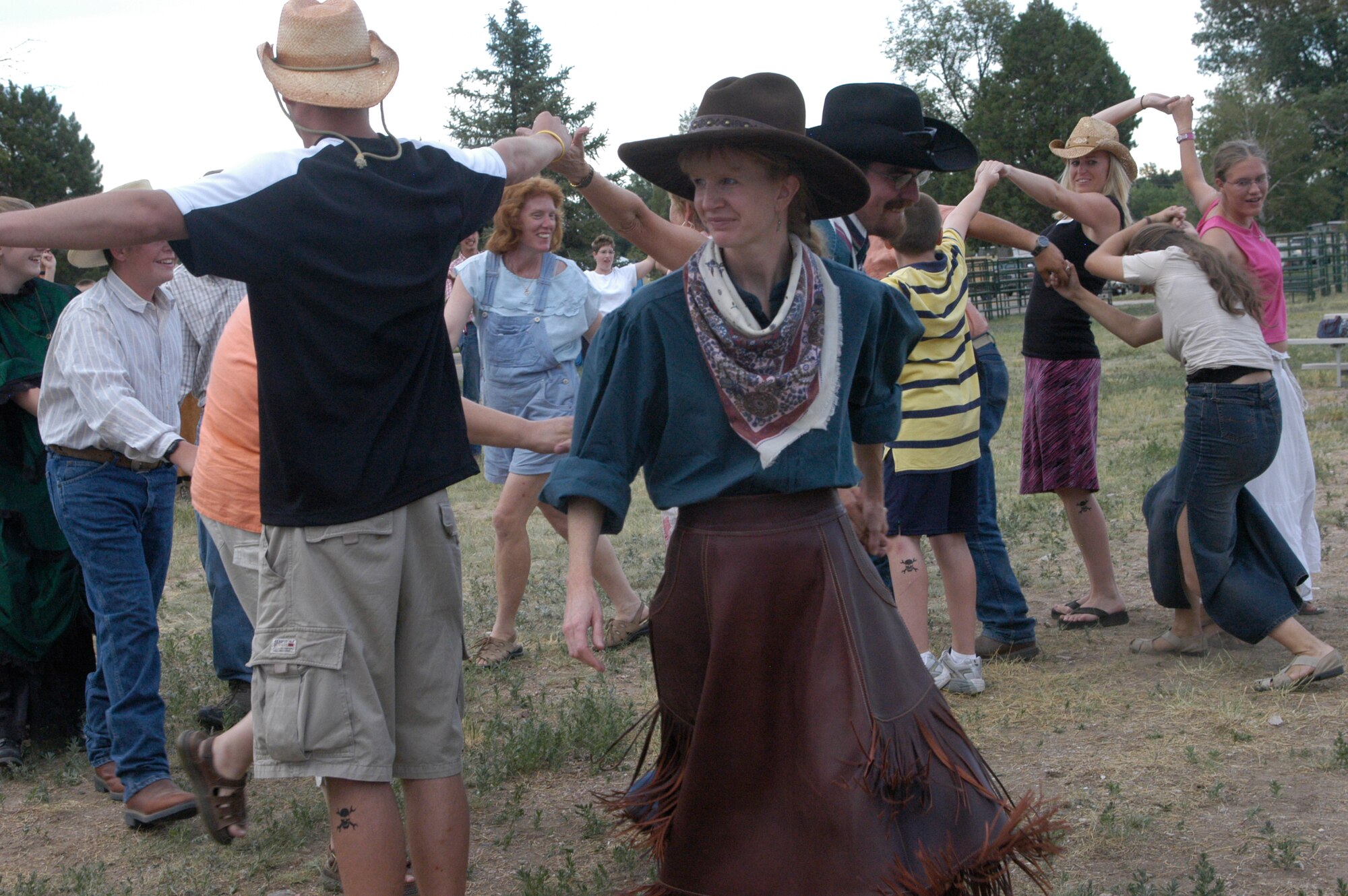 Colorado resident Sharon Bellvue, caller of western dances at the ice cream social and dance, weaves two dance lines through one another at the social during Fort D.A. Russell Days here. Dancers were taught to promenade, swing their partner and do-si-do after having ice cream (Photo by 2nd Lt. Lisa Meiman).