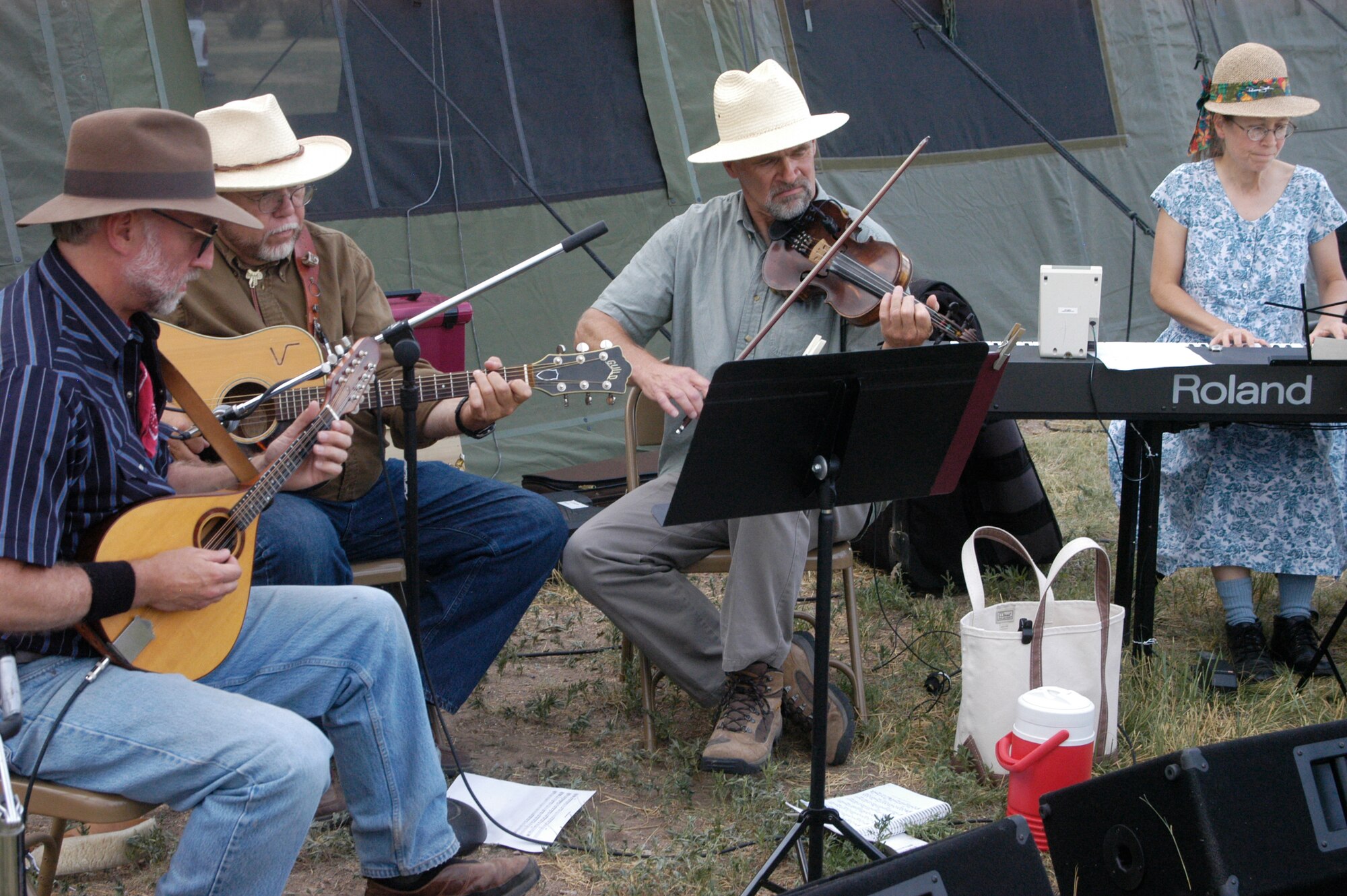 Tim Macomber, Bill McKay, Doug Woody and Kim Harris, members of the local band The Usual Suspects, entertain the audience at the ice cream social and dance July 21 as part of Fort D.A. Russell Days. The band first provided background music while attendees ate ice cream. They then played western dance music (Photo by 2nd Lt. Lisa Meiman).