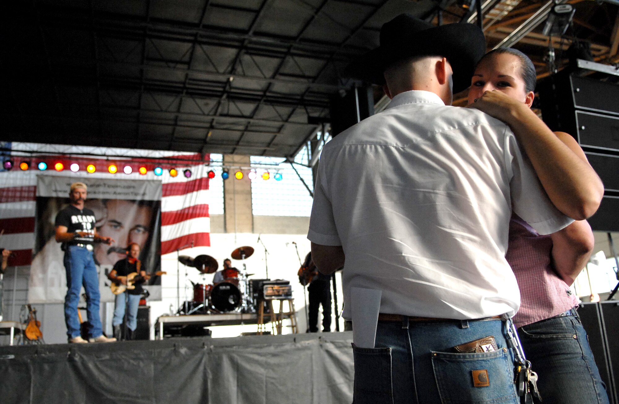 MOUNTAIN HOME AIR FORCE BASE, Idaho -- A couple dances while Aaron Tippin sings a love song during the 2007 Spirit of America Tour concert July 31. The tour, founded in 2002 by Robert Rosenthal, brings free concerts to stateside, military installations to thank U.S. troops for all they do. (U.S. Air Force photo/Airman 1st Class Ryan Crane)