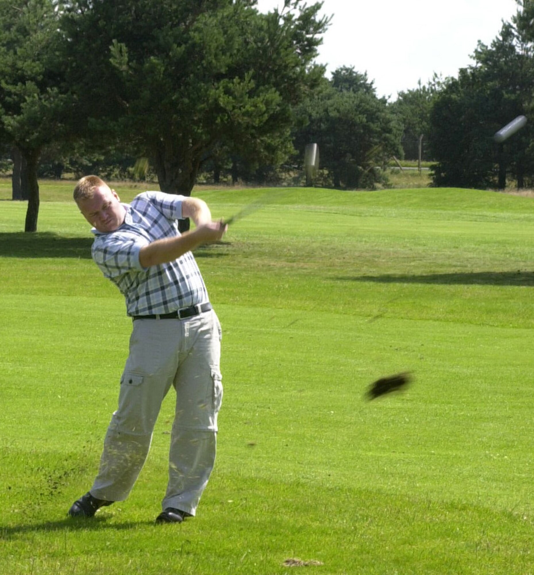 Jim Rose playing for 373rd Training Squadron hits a shot out of the light rough on the 16th hole in the intramural golf league at the Breckland Pines Golf Club, July 31. (Air Force photo by Gary Rogers)