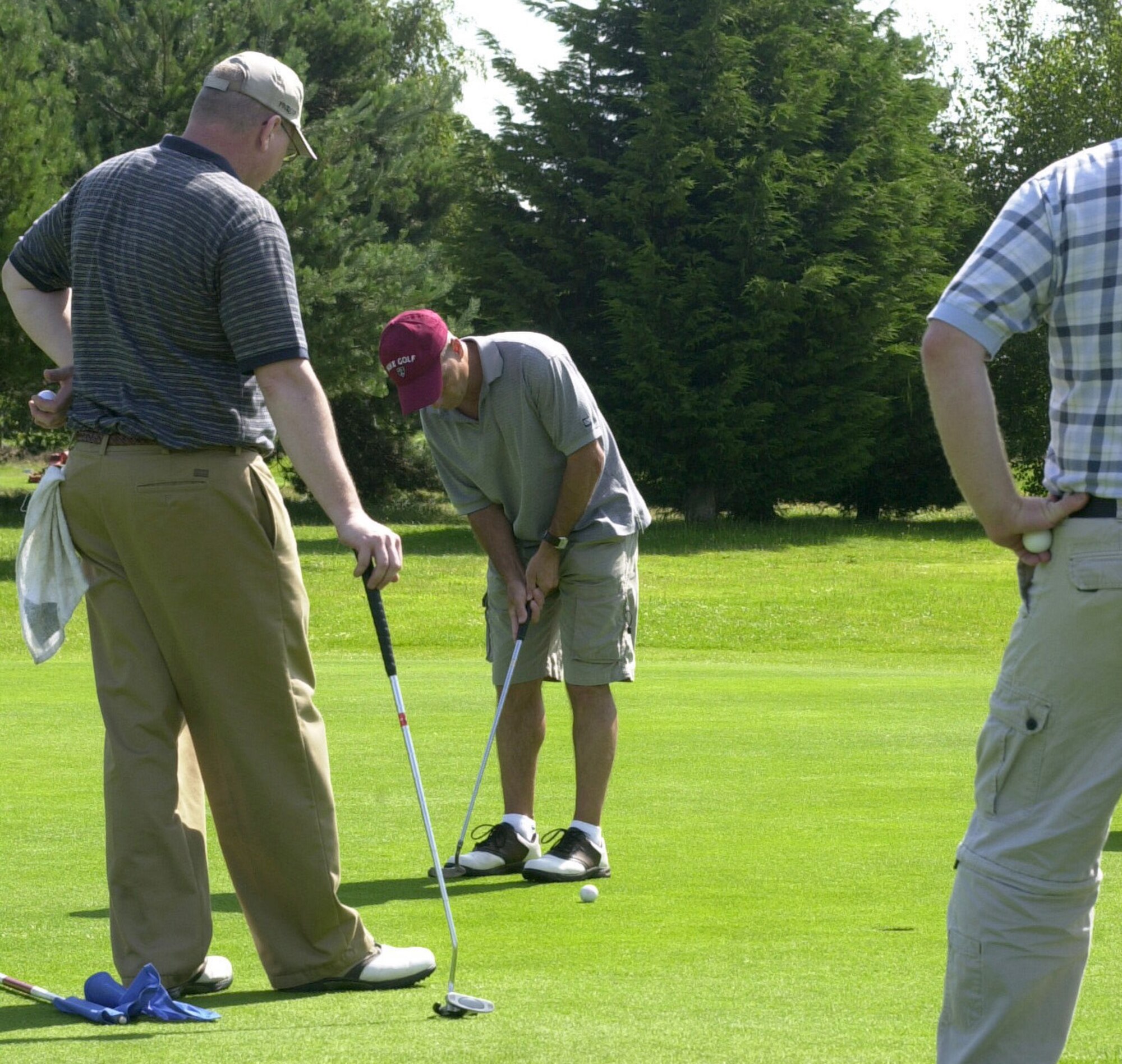 Mark Gagnon, playing for the 100th Mission Support Squadron holes out for a par on the 15th green in the intramural golf league at Breckland Pines Golf Club July 31. (Air Force photo by Gary Rogers)