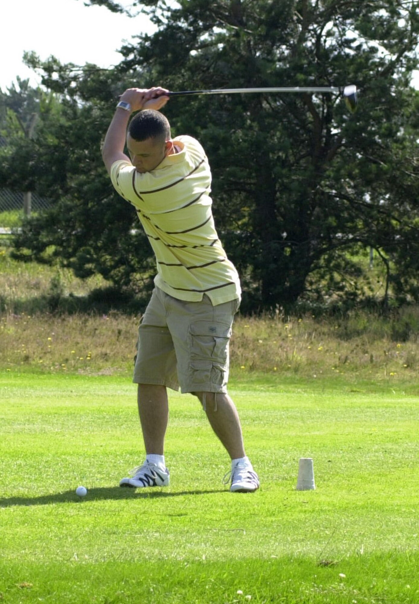 Shaye Melton, playing for the Defence Courier Service, drives off the 18th tee box in the intramural golf league at the Breckland Pines Golf Club July 31. (Air Force photo by Gary Rogers)