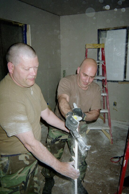 The 911th Airlift Wing's Civil Engineering Squadron, in conjunction with the Southwest Indian Foundation, traveled to Gallup, N.M., on April 30, 2007, to build homes for indigent and disadvantaged American Indian families in the area. Staff Sgt. Robert Shaner, left, and Master Sgt. Thomas Venenzio are seen here preparing to hang drywall in one of the new homes. (photo by Master Sgt. William Fulkerson 911 AW/CE)