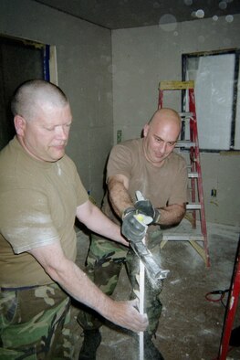 The 911th Airlift Wing's Civil Engineering Squadron, in conjunction with the Southwest Indian Foundation, traveled to Gallup, N.M., on April 30, 2007, to build homes for indigent and disadvantaged American Indian families in the area. Staff Sgt. Robert Shaner, left, and Master Sgt. Thomas Venenzio are seen here preparing to hang drywall in one of the new homes. (photo by Master Sgt. William Fulkerson 911 AW/CE)