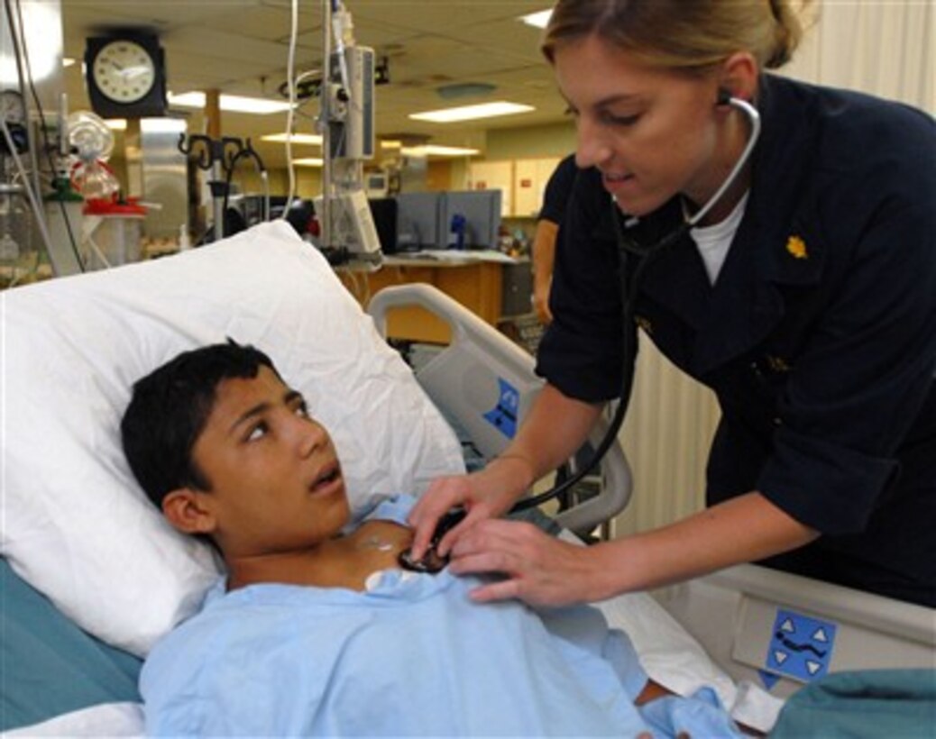 U.S. Navy Lt. Megan Zeller, an intensive care unit nurse, checks the vital signs of a young boy recovering from surgery aboard the hospital ship USNS Comfort (T-AH 20) in Acajutla, El Salvador, on July 31, 2007.  The Comfort is on a four-month humanitarian deployment to Latin American and Caribbean countries providing medical care for patients.  