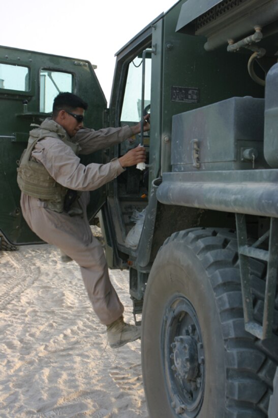 MARINE CORPS AIR STATION MIRAMAR, Calif. - Staff Sgt. Ingrid Melvin, the staff non-commissioned officer-in-charge of the recycling center, removes cardboard boxes from the collection trailer. The cardboard boxes are placed into the industrial bailer and transformed into one-ton bails. (U.S. Marine Corps Photo by Lance Corporal Jessica Aranda)