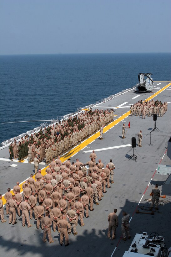 Marines and sailors of Marine Medium Helicopter Squadron 261 (Reinforced) stand in formation on the flight deck of the USS Kearsarge, prior to being addressed by the Commanding General of II Marine Air Wing, MajGen. Kenneth J. Glueck Jr.  August 1, 2007. HMM-261 (Reinforced), is the Aviation Combat Element of the 22nd Marine Expeditionary Unit (Special Operations Capable). (Official Marine Corps photo by Sgt. Ezekiel R. Kitandwe) (Released)