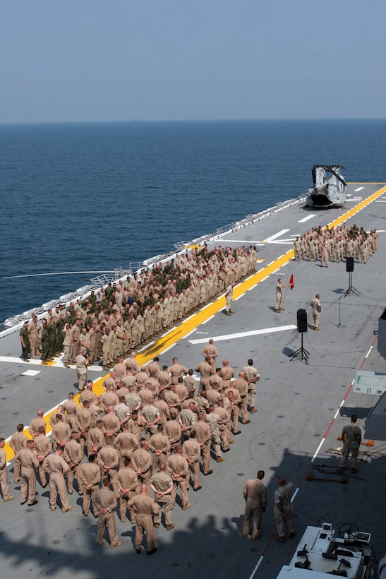 Marines and sailors of Marine Medium Helicopter Squadron 261 (Reinforced) stand in formation on the flight deck of the USS Kearsarge, prior to being addressed by the Commanding General of II Marine Air Wing, MajGen. Kenneth J. Glueck Jr.  August 1, 2007. HMM-261 (Reinforced), is the Aviation Combat Element of the 22nd Marine Expeditionary Unit (Special Operations Capable). (Official Marine Corps photo by Sgt. Ezekiel R. Kitandwe) (Released)