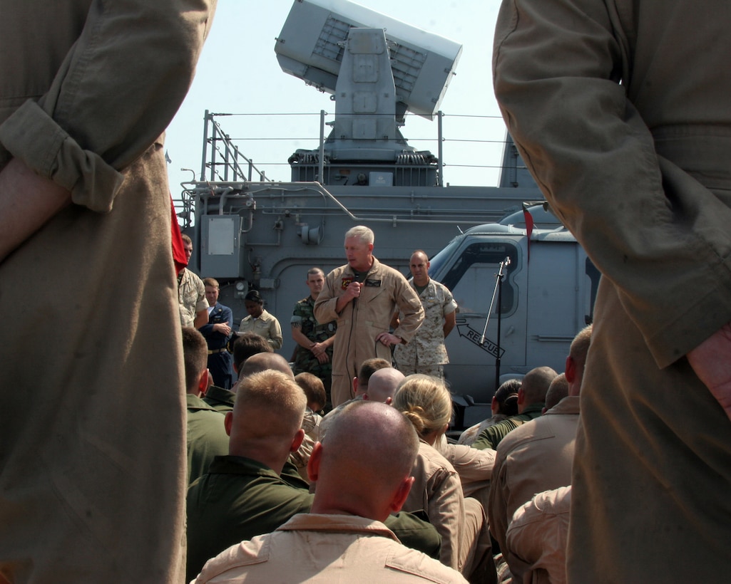 Marines and sailors of Marine Medium Helicopter Squadron 261 (Reinforced) listen to Major Gen. Kenneth J. Glueck Jr., the commanding general of the 2nd Marine Air Wing aboard the USS Kearsarge Aug. 1, 2007. Glueck was visiting the "Raging Bulls” one last time before they departed on a scheduled deployment as the Aviation Combat Element of the 22nd Marine Expeditionary Unit (Special Operations Capable). (Official Marine Corps photo by Sgt. Ezekiel R. Kitandwe)
