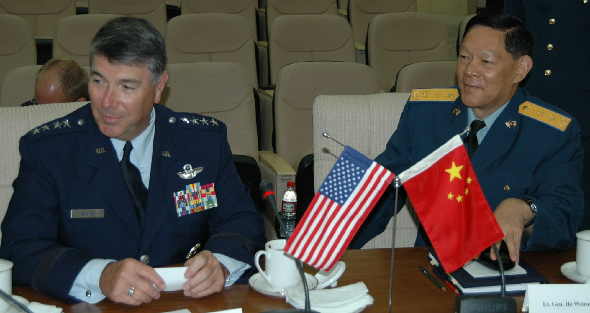 BEIJING—Gen. Paul V. Hester, commander of Pacific Air Forces, and Lt. Gen. He Weirong, deputy commander of the People’s Liberation Army Air Force, await to receive the PLAAF mission briefing July 24. (U.S. Air Force photo by Maj. Ray Truong)
