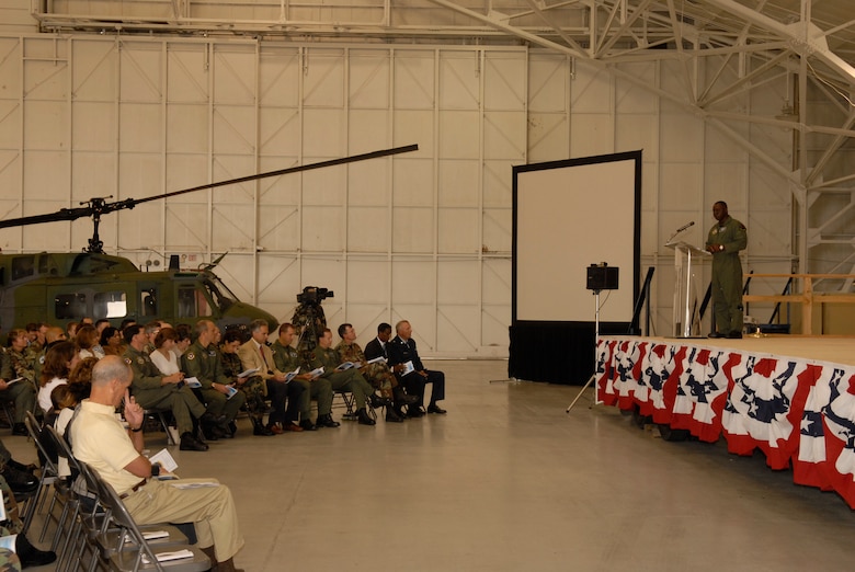 VANDENBERG AIR FORCE BASE, Calif. -- 30th Operations Group Commander Col. Andre Lovett speaks to an audience of about 100 people during the 76th HS inactivation ceremony at the hangar on Aug. 2. The squadron supported space launch, land and water rescue, fire suppression and many diverse training missions. (U.S. Air Force photo/Airman 1st Class Adam Guy) 