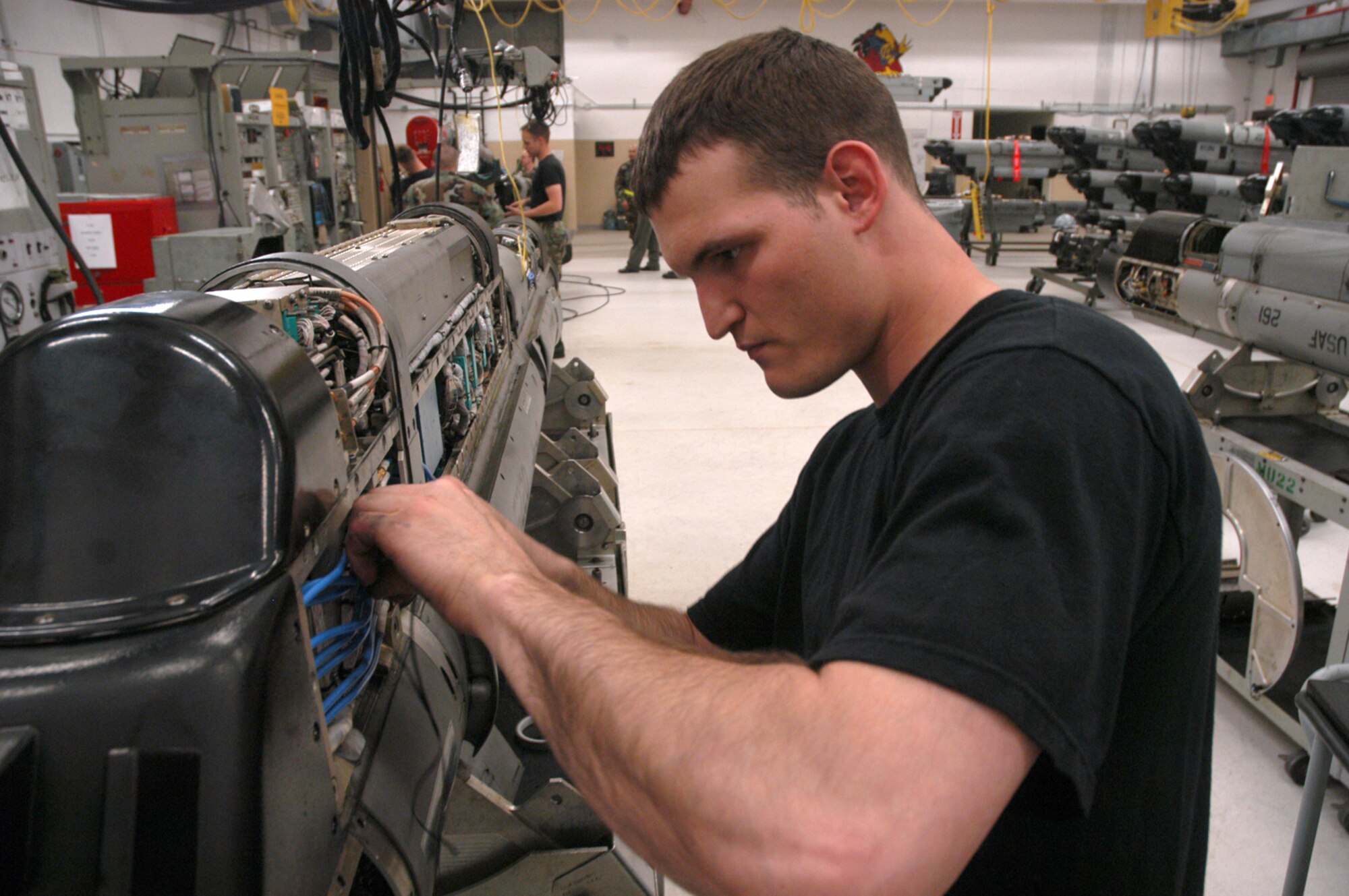 KUNSAN AIR BASE, Republic of Korea -- Senior Airman Chad Engelman, 8th MXS electronic warfare systems journeyman, ties down electrical components in an electronic countermeasure pod. The ECM maintenance shop recently achieved a milestone for the 8th Fighter Wing "Wolf Pack" July 13, reaching a 100 percent fully-mission capable rate for the first time. (U.S. Air Force photo/Senior Airman Stephen Collier)

