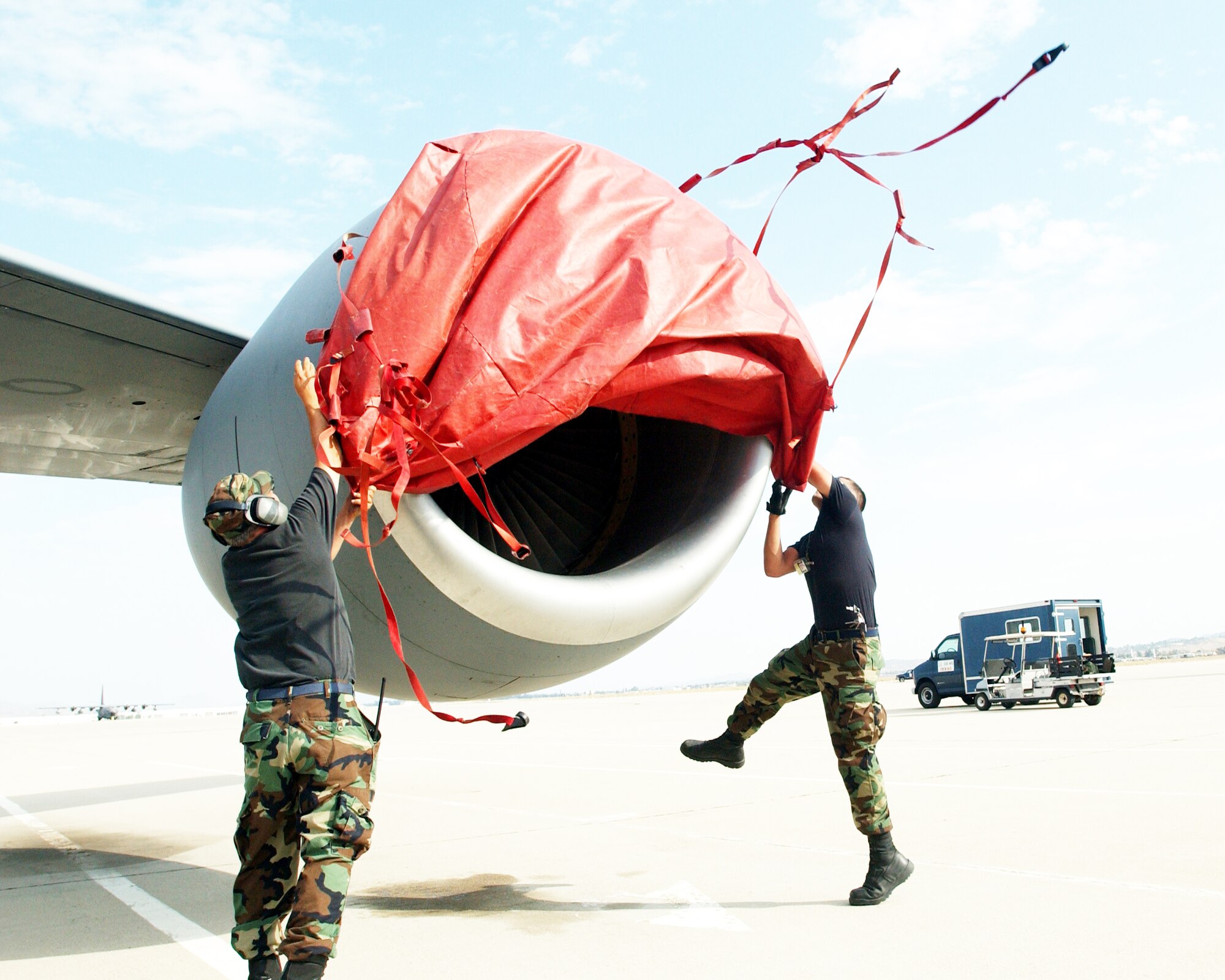 Tech Sgt. David Domagalski and Senior Airman David Reed, 752nd Aircraft Maintenance Squadron, pull a tarp over a KC-135 Stratotanker engine at March Air Reserve Base, Calif., during Patriot Hook 2007. Patriot Hook is a five-day training exercise taking place at three California airfields -- March ARB, North Island and San Clemente Island -- in which military branches come together to practice operational capabilities in a deployed setting.
U.S. Air Force photo by Airman 1st Class Joseph Araiza