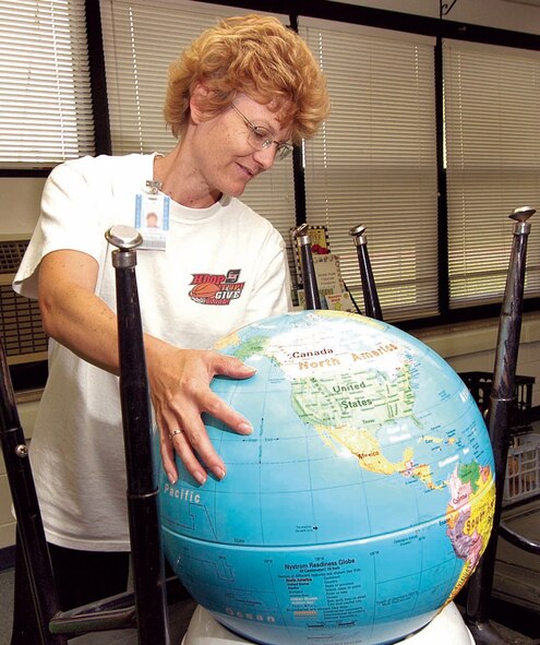 Tinker Elementary School second-grade teacher Vicki Dudley unpacks and unstacks her classroom, getting it ready for the new school year, which begins Aug. 14. (Air Force photo by Margo Wright)