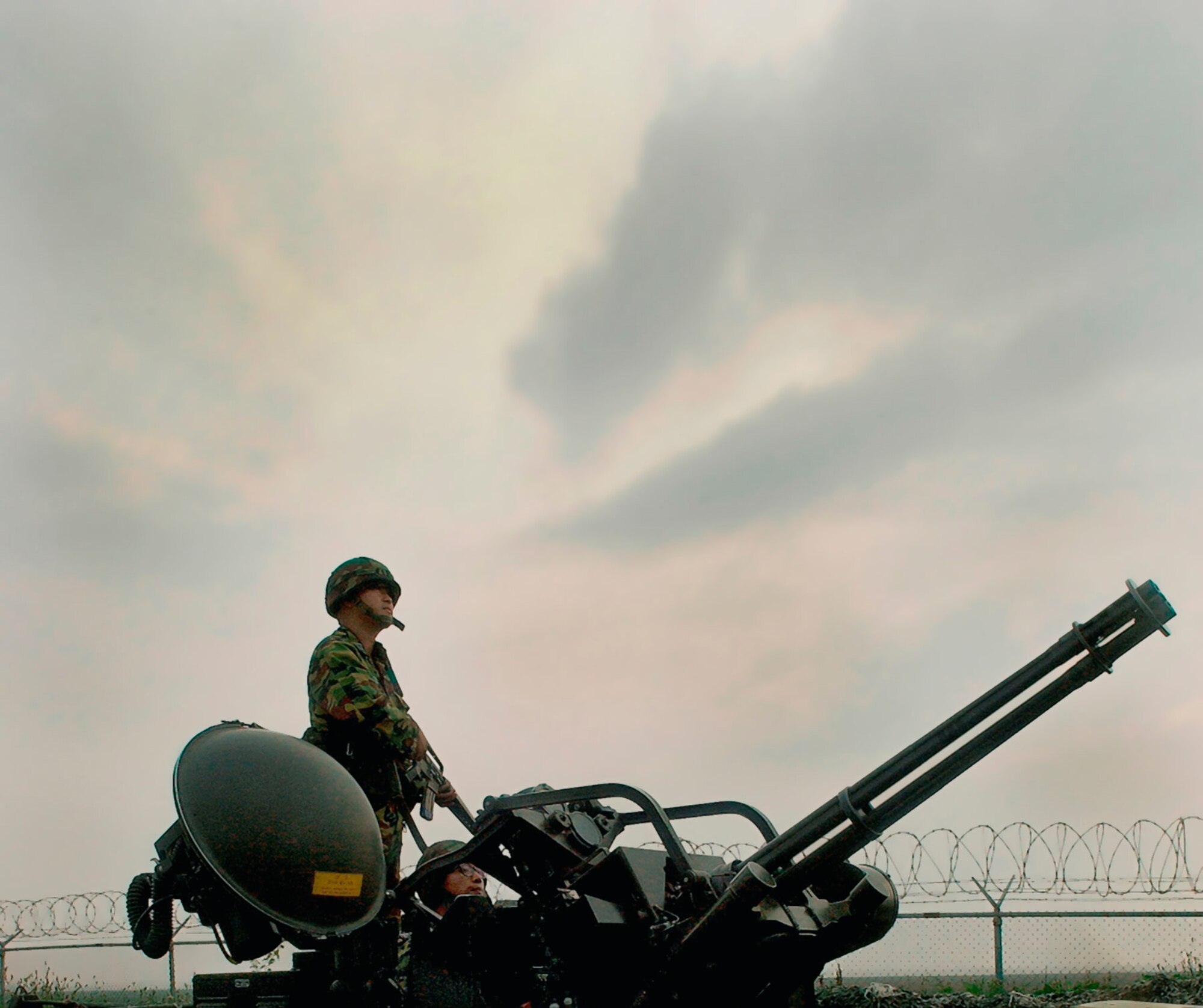 Korean Air Force Staff Sgt. Donghoon Lee directs a fellow Republic of Korea Airman during operation of the M-61 20 mm Vulcan cannon July 24 at Kunsan Air Base, Republic of Korea. Airmen from the 38th Fighter Group and 8th Security Forces Squadron work and train together to better enhance the base's defense plan in the event of hostilities on the peninsula. The Korean Airmen are assigned to the 38th FG anti-aircraft battery. (U.S. Air Force photo/Senior Airman Giang Nguyen)