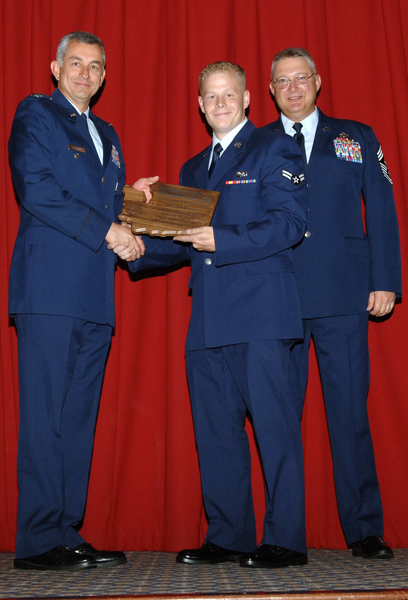 FAIRCHILD AIR FORCE BASE, Wash. -- Ten quarterly award winners from Fairchild and the 92nd Air Refueling Wing were announced at a luncheon and ceremony Aug. 1 at Club Fairchild here. Here, Airman 1st Class Robert McCampbell of the 92nd Logistics Readiness Squadron accepts his title as 92nd ARW Airman of the Quarter, second quarter. In addition to the individual award winners, two dorm of the quarter awards were also announced. (U.S. Air Force photo/ Airman 1st Class Jocelyn Ford) 
