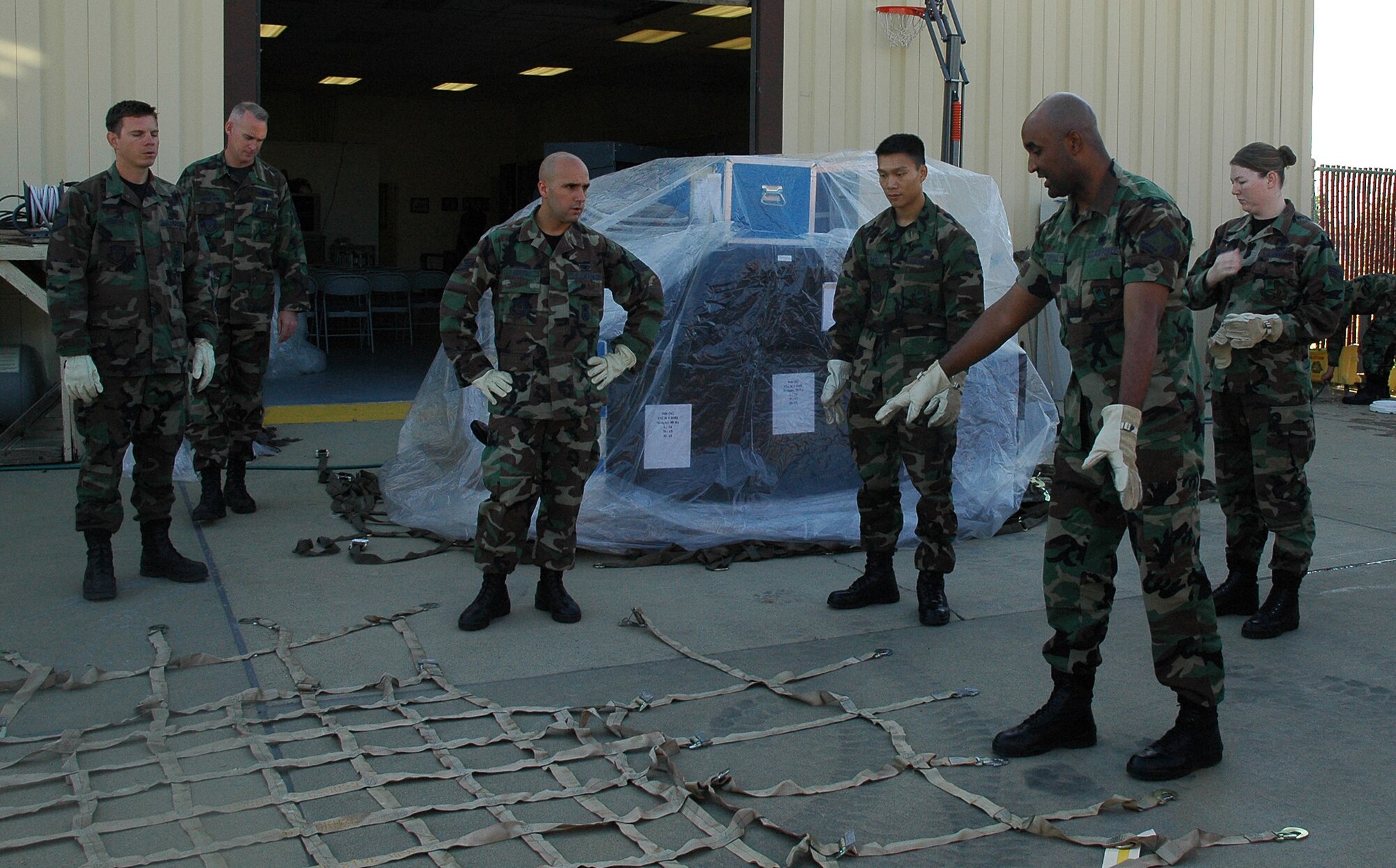 Air Force Reservist Master Sgt. Antione Stovall, a traffic management specialist with the 940th Logistics Readiness Squadron, instructs Citizen Warriors from the 940th Air Refueling Wing at Beale Air Force Base, Calif. in the proper technique for securing cargo netting to a pallet of supplies. This valuable training is in preparation for the wing?s Operational Readiness Inspection in February 2008. The ORI will test the ability of the 940th Citizen Airmen to deploy personnel and equipment during contingency situations. (U.S. Air Force photo/ Staff Sgt. Luke Johnson)