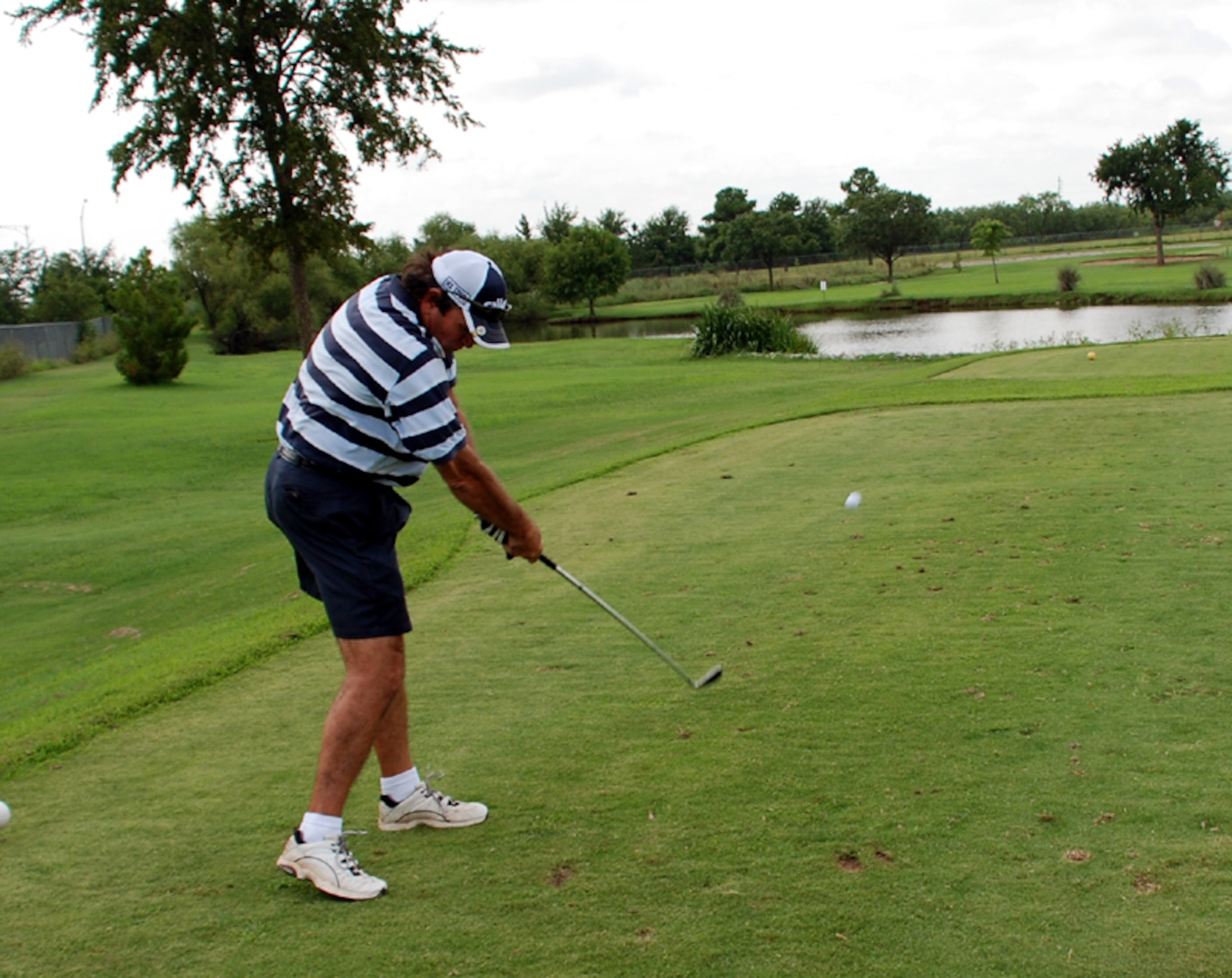 Billy Irions, a sports specialist with the 82nd Mission Support Group,  hits the ball at a farewell golf tournament held in honor of Col. Stevenl McKay, 82nd MSG commander, Aug. 2 at the Wind Creek Golf Course. (U.S. Air Force photo/Cadet Third Class Justin North)
