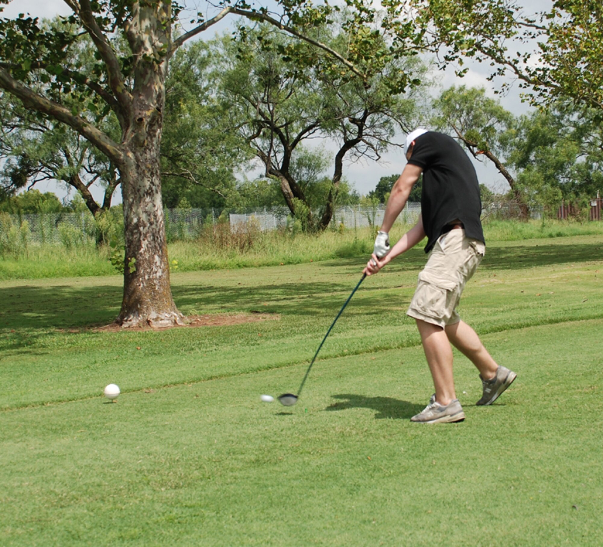 Abram McKay, son of Col. Steven McKay, 82nd Mission Support Group commander, hits the ball at a farewell golf tournament held in honor of Colonel McKay Aug. 2 at the Wind Creek Golf Course. (U.S. Air Force photo/Cadet Third Class Justin North)
