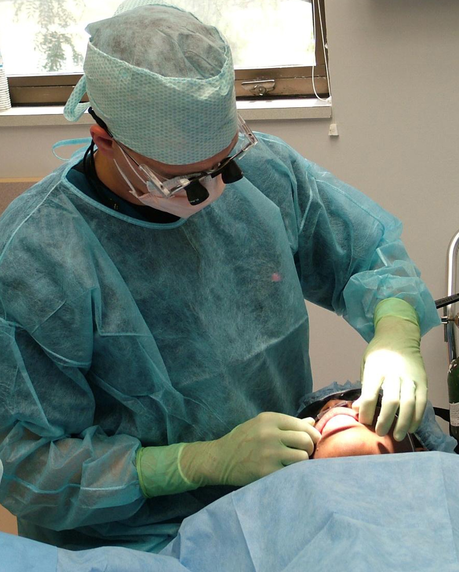 Capt. (Dr.) Bradford Allen performs a presurgical evaluation on a patient. (U.S. Air Force photo by Maj. [Dr.] Dennis Holt)
