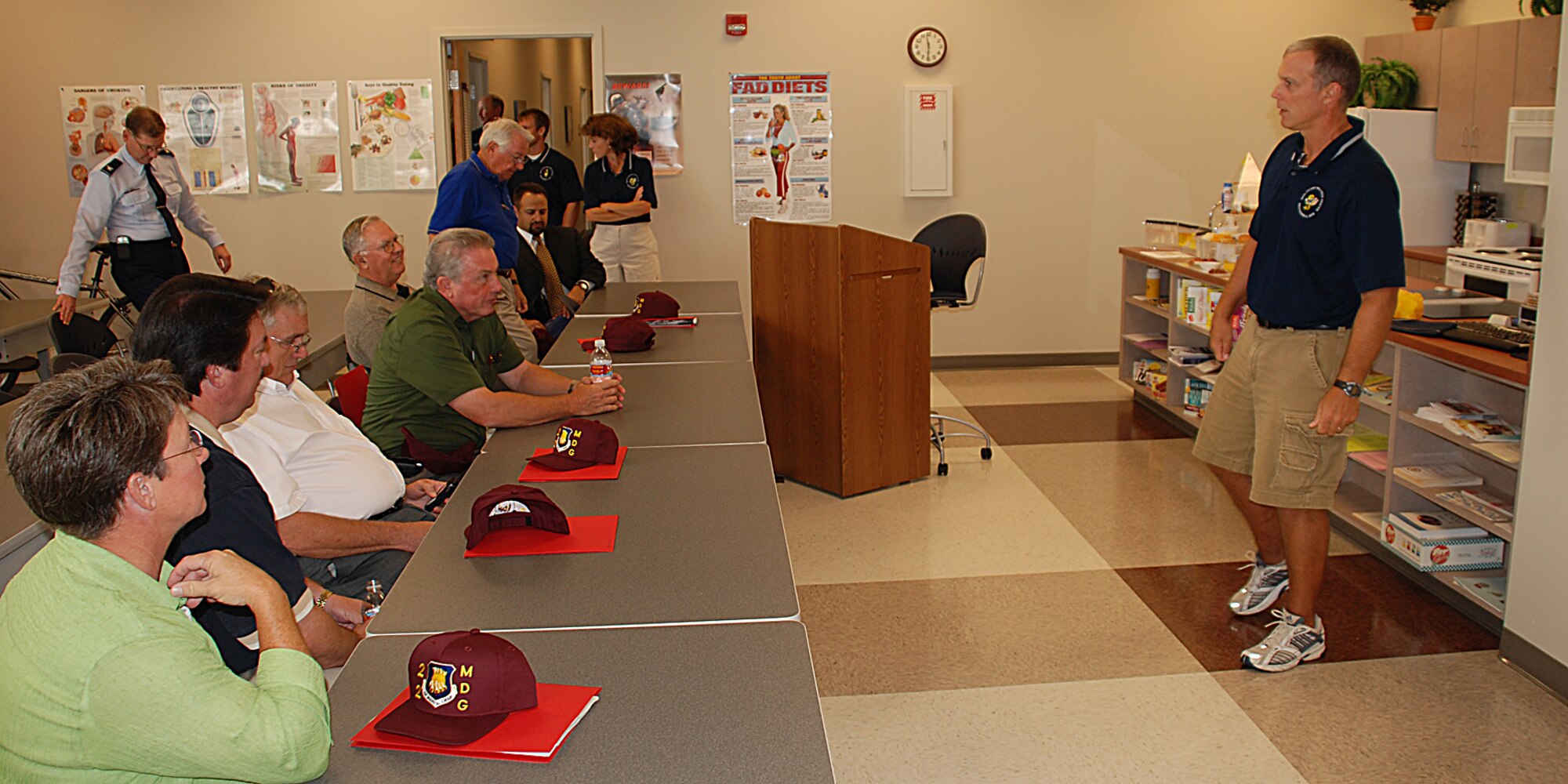 MCCONNELL AIR FORCE BASE, Kan. -- Lou Stadler, Heath and Wellness Center’s health promotion flight chief, explains to honorary commanders how the HAWC provides quality heath and fitness education and programs during a medical group orientation July 31.The HAWC also provides comprehensive evaluations of fitness levels to servicemembers and their families. (photo by Airman 1st Class Jessica Lockoski)